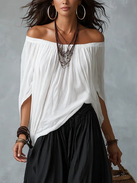 White ensemble with an off-the-shoulder top and lantern-style pants
