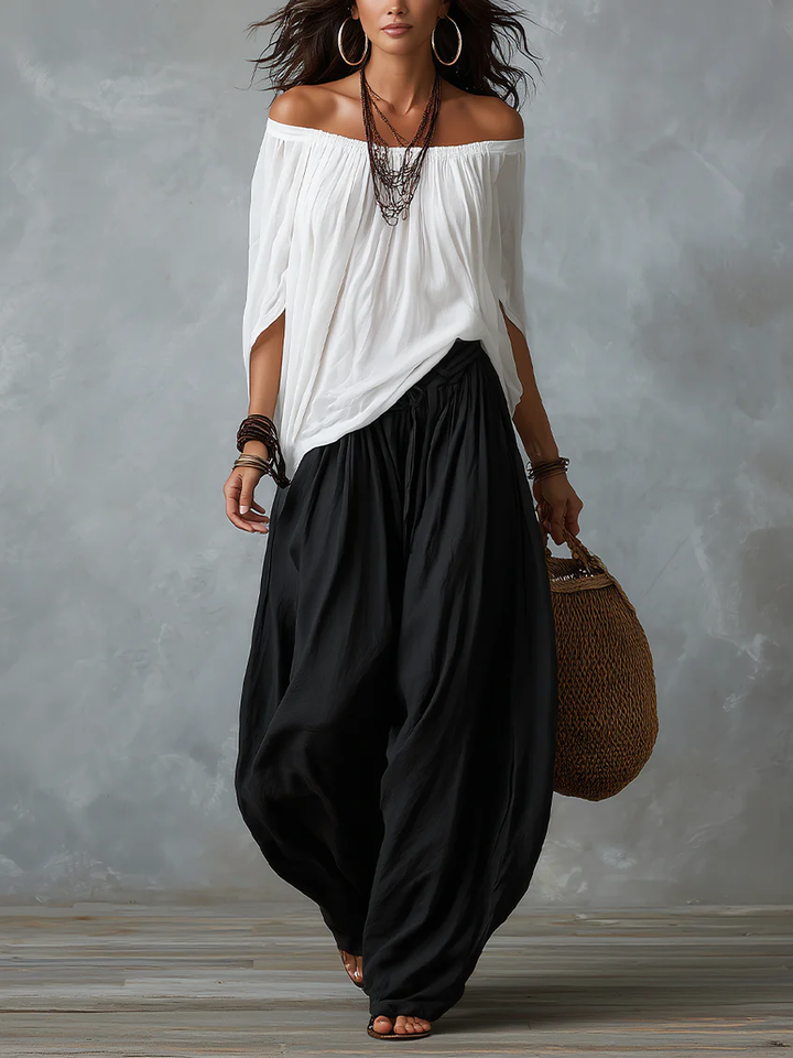 White ensemble with an off-the-shoulder top and lantern-style pants