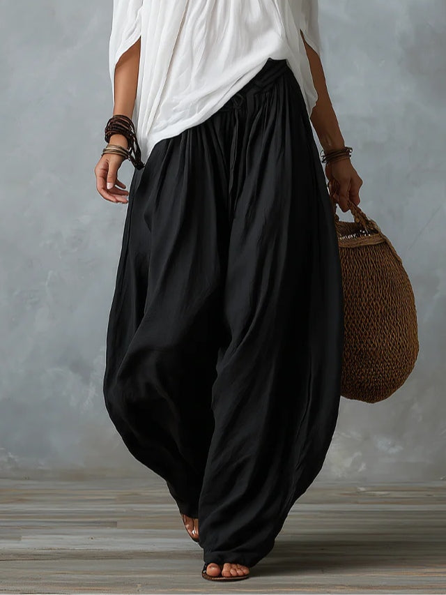 White ensemble with an off-the-shoulder top and lantern-style pants